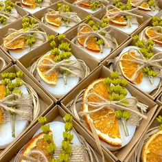 several boxes with orange slices and green flowers in them are arranged to look like they have been cut open