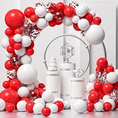 red, white and silver balloon arch with confetti on the top for decoration