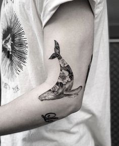 a man's arm with a banana tattoo on the left side of his arm