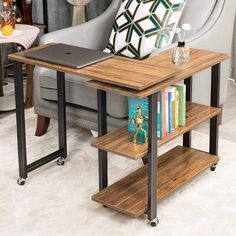 a laptop computer sitting on top of a wooden table next to a gray couch and chair