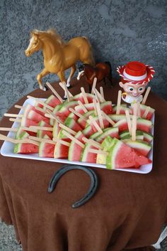 watermelon skewers with horse figurines on the top are ready to be served