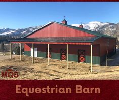 a red barn sitting on top of a dry grass covered field with mountains in the background