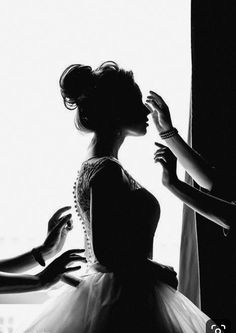 the woman is getting ready to go into her wedding dress