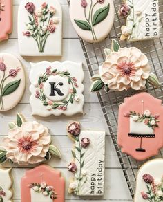 some decorated cookies are sitting on a cooling rack