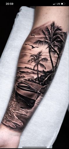 a man's arm with a boat and palm trees on it