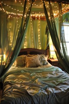 a bed covered in green curtains and lights