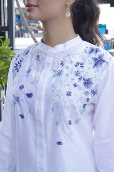 White top embroidered with blue resham embroidery in floral motifs. - Aza Fashions Traditional Floral Embroidered Festive Shirt, Traditional Floral Embroidery Festive Shirt, Blue Cotton Top For Wedding, Festive Shirt With Floral Embroidery, Festive White Top With Embroidered Sleeves, Designer Blue Tops With Resham Embroidery, Designer Wear Blue Tops With Resham Embroidery, White Intricate Embroidery Festive Top, White Tops With Intricate Embroidery For Festive Season