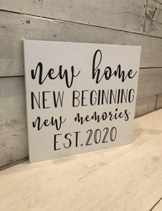 a wooden sign that says new home, new beginnings and memories