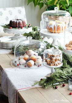 a table topped with lots of cakes and desserts