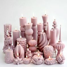 many pink candles are lined up on the table