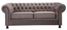 a grey couch with buttons on the back and arm rests against a white background,