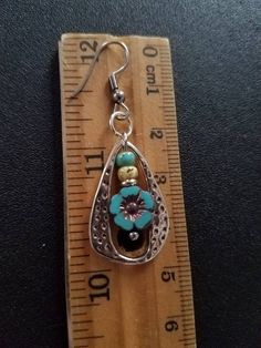 This listing is for one pair of Czech turquoise hibiscus flower earrings framed in silver. Beautiful turquoise flower topped by turquoise and antiqued bone colored Picasso glass. Great compliment to a Southwest or boho look. Great gift for mom. Measures 48x16mm hooks 35x16mm posts Save on shipping! I will batch ship items in an order for one price or Free shipping on orders of $20 or more. Use coupon code FREESHIP2019 at checkout Turquoise Teardrop Flower Earrings For Gift, Handmade Antique Silver Flower Pendant Jewelry, Nickel-free Sterling Silver Teardrop Flower Earrings, Turquoise Flower Charm Earrings For Gift, Turquoise Jewelry With Flower Charm, Metal Flower Earrings As Gift, Gift Turquoise Flower Charm Earrings, Turquoise Flower Earrings As A Gift, Bohemian Sterling Silver Jewelry With Flower Charm