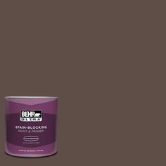 a can of behrut ultra stain - blocking paint on a dark brown background