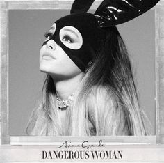 a woman wearing a bunny mask with long hair in front of a black and white photo