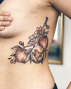 a woman's stomach with an apple tattoo on her belly and the top half of her body