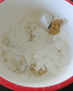 a red and white bowl filled with flour