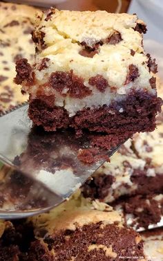 a close up of a piece of cake on a plate with a spatula in it