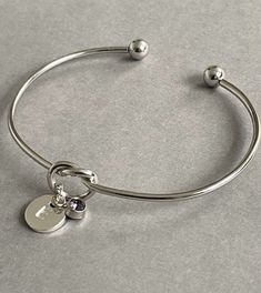 Pretty silver initial June birthstone bracelet bangle - an ideal personalised gift for a loved one or would make a lovely personalised gift for a Bridesmaid. A gift note can be added (any text can be written) just remember to add the note in the 'personalisation box'. + Bangle is adjustable so will fit most girls and women (to tighten the bangle gently squeeze it to make it smaller) + Silver plated bangle + Silver plated initial charm + Silver plated birthstone charm + Disc initial charm measure Adjustable Silver Name Bracelet With Birthstone, Silver Name Charm Bracelet For Gift, Silver Name Charm Bracelet Gift, Sterling Silver Initials Bracelet For Personalized Gift, Adjustable Initials Bangle Bracelet, Silver Birthstone Bracelets For Gift, Silver Birthstone Bracelet For Gift, Adjustable Silver Bracelet As Personalized Gift, Silver Minimalist Personalized Bangle