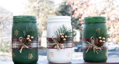 three mason jars decorated with pine cones and plaid bows