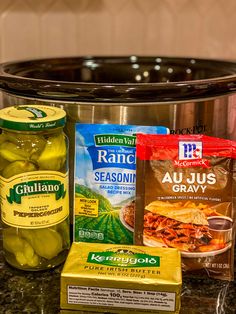 pickles, seasonings, and spices sit in front of an instant pot