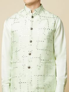 This Mint Green Kurta Bundi Jacket Set will instantly give an elegant look. This 3 piece kurta bundi set features a mint green mirror embroidered bundi jacket with a mint green kurta, front button placket, and a mandarin collar. It is paired with white churidar pants. An ideal outfit for traditional occasions, and special events.

Size Chart For Men





	
	
					Men's Size Chart
		

		
		
						
				Size Chart For Men
				Custom Size Measurement Guide
			
			
				
				
				Custom Size Measureme Spring Party Kurta With Mirror Work, Spring Pista Green Kurta With Mirror Work, Spring Festive Nehru Jacket With Gota Work, Green Long Sleeve Sherwani For Spring, Festive Green Nehru Jacket For Party, Spring Green Embroidered Sherwani, Spring Wedding Sherwani With Gota Work, Spring Wedding Nehru Jacket With Gota Work, Spring Embroidered Green Sherwani