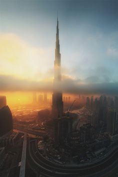 an aerial view of the burj tower in dubai, with fog covering it