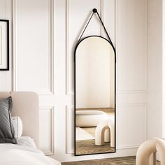 a large mirror hanging on the wall above a bed