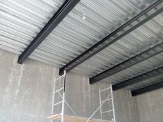 a metal structure with scaffolding on the ceiling