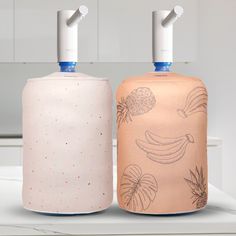 two air freshener dispensers sitting on top of a counter next to each other