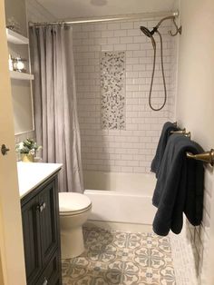 a bathroom with a toilet, sink and bathtub in the shower stall is shown