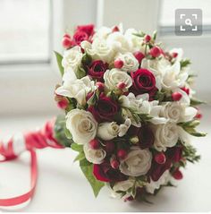 a bridal bouquet with red and white flowers