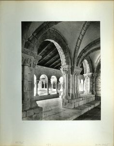 an old black and white photo of a building with arches on the ceiling, and stone flooring