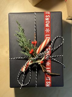 a present wrapped in black paper and tied with twine