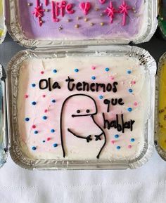 four trays filled with cake covered in frosting and writing on the top one has an image of a man's face