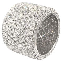 a white gold ring set with round brilliant pave cut diamonds on the outside of it