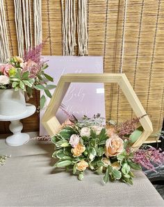 two vases with flowers are sitting on a table