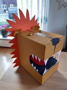 a cardboard box with an animal's head and mouth cut out on the inside