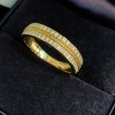 a gold ring with white diamonds in it