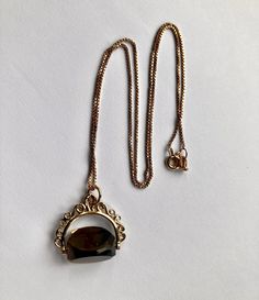 Attractive pre loved solid 9k gold spinning Smokey quartz fob and fine box link 17 inch long chain. CONDITION: Very good  FOB SIZE 20mm x 25mm CHAIN LENGTH: 17 inches ( 43.18cm long ) This necklace has a 9ct gold hallmark on it ( 375 gold ) but in addition has been professionally checked, cleaned and polished. Comes in a new box. Victorian Gold Chain Jewelry As Gift, Victorian Gold Chain Jewelry Gift, Victorian Gold Chain Jewelry For Gifts, Victorian Style Gold Chain Jewelry As Gift, Antique Gold Chain Necklace Gift, Antique Gold Chain Necklace For Gift, Smokey Quartz, Long Chain, Chain Lengths