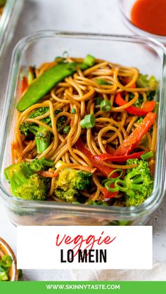 vegetable lo mein in a glass dish with broccoli and peppers on the side