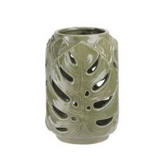 a green vase is shown with holes in the center and an intricate design on it