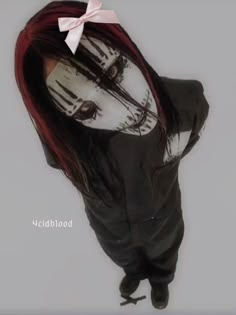 a woman with red hair wearing a creepy mask