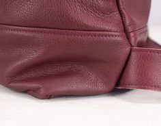 "The Minos backpack made out of a soft burgundy soft Italian cowhide. It comes in two sizes. The Minos-13 that fits a 13\" MacBook inside and the Minos-15 for up to 15\" MacBook. Customizations regarding sizes or the laptop pocket's size inside are always welcome. This backpack is great for all your everyday necessities including your 13\" or 15\" MacBook, work papers, magazines etc. In front, there are two zippered vertical pockets sealed with YKK brass zippers placed on each side. They measure Everyday Burgundy Backpack, Leather Backpack With Adjustable Strap In Burgundy, Burgundy Backpack With Adjustable Strap For Daily Use, Leather Burgundy Backpack With Adjustable Strap, Burgundy Standard Backpack For Everyday Use, Burgundy Leather Travel Backpack, Burgundy Leather Backpack With Adjustable Strap For Everyday, Burgundy Leather Backpack With Adjustable Strap, Daily Use Burgundy Leather Backpack