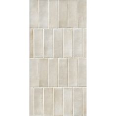 a white tile wall that is very clean and ready to be used in the bathroom