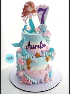 a birthday cake with a little mermaid on top