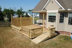 a wooden deck in front of a house