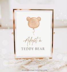 a teddy bear sign with the words adopt a teddy bear in gold foil on it