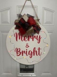 a merry and bright sign hangs on the front door