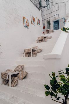 there are many chairs on the stairs in front of this building with pictures on the wall