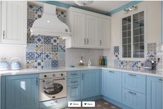 a kitchen with blue cabinets and white counter tops